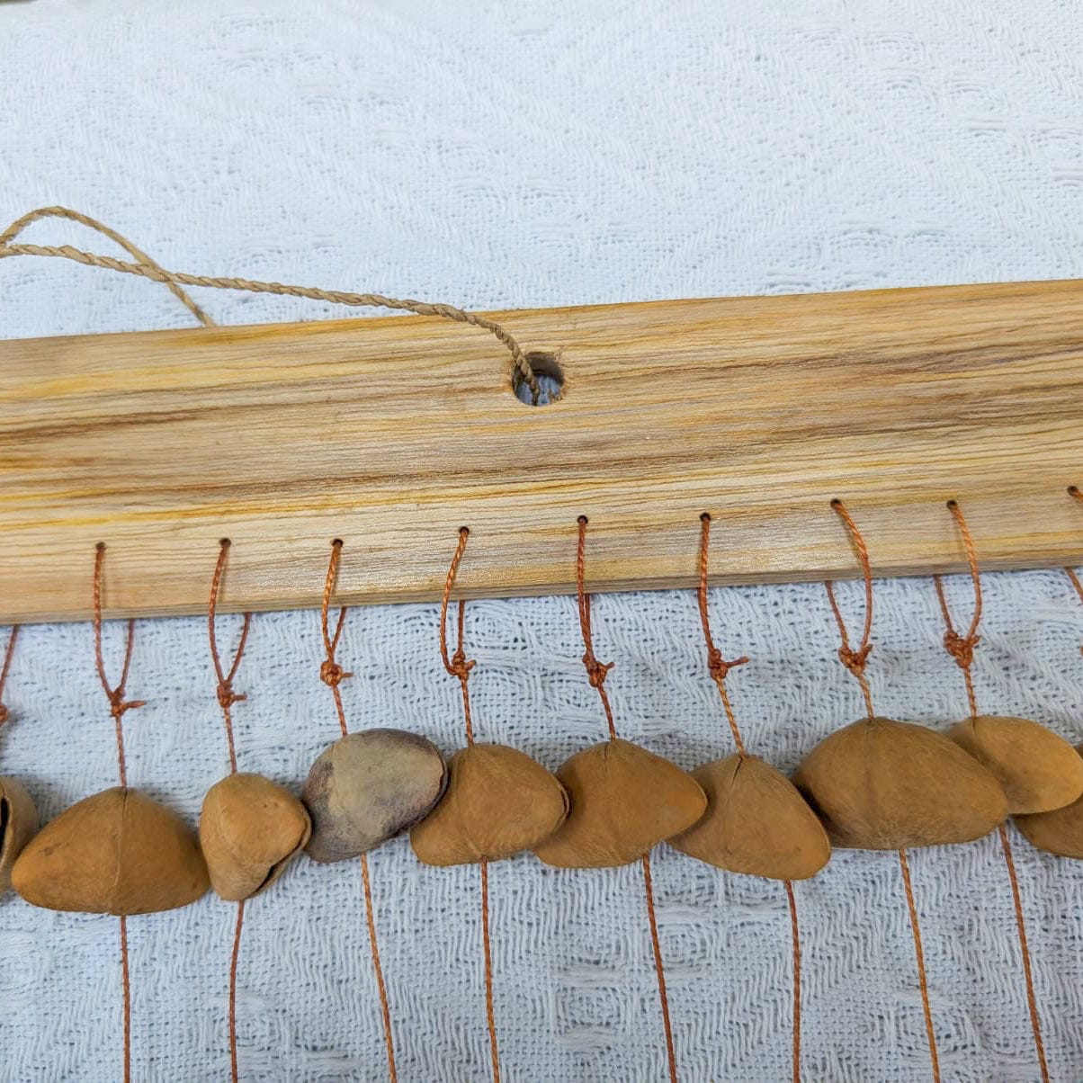 Handmade Kenari pod wind chimes from West Africa, natural sound healing decor