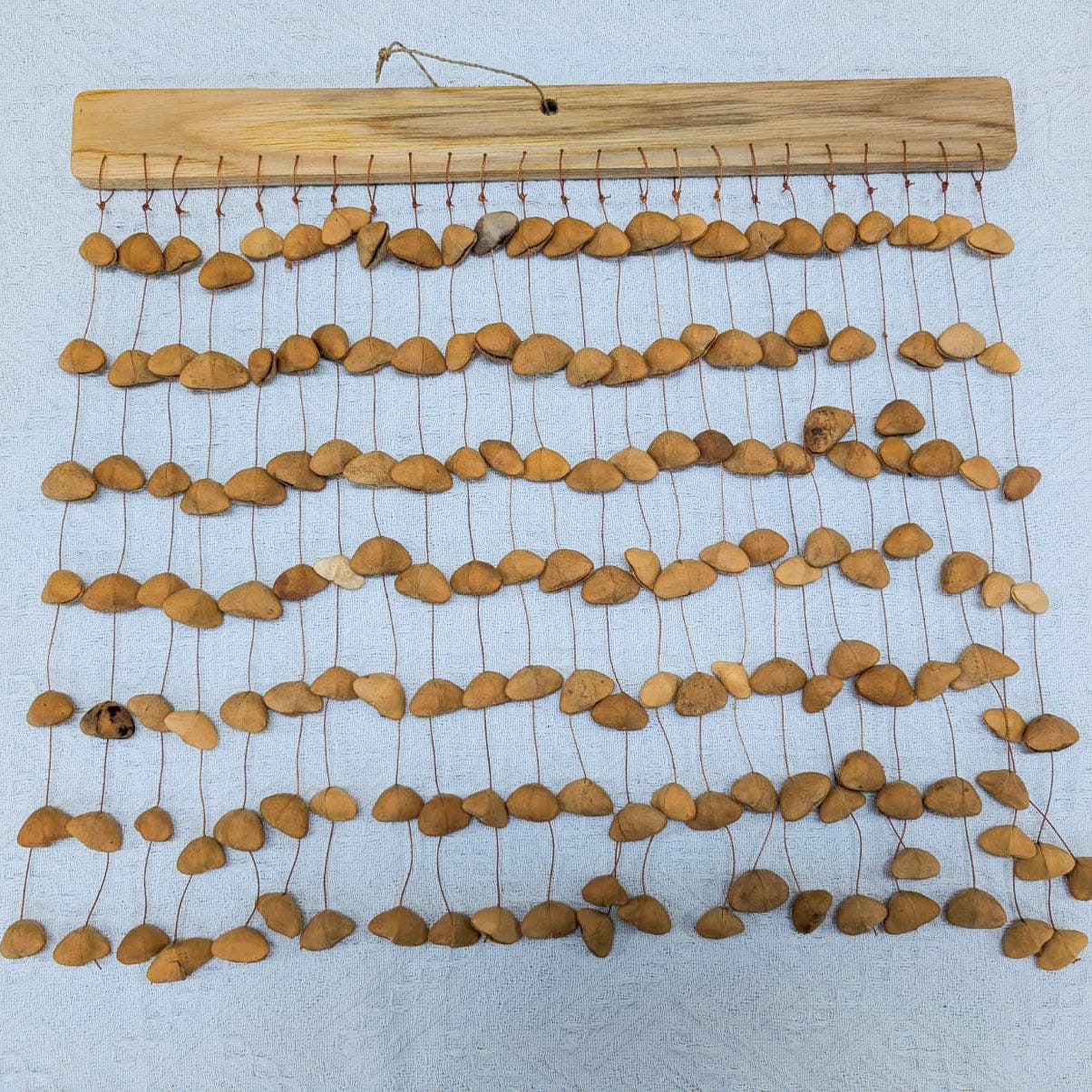 Handmade Kenari pod wind chimes from West Africa, natural sound healing decor