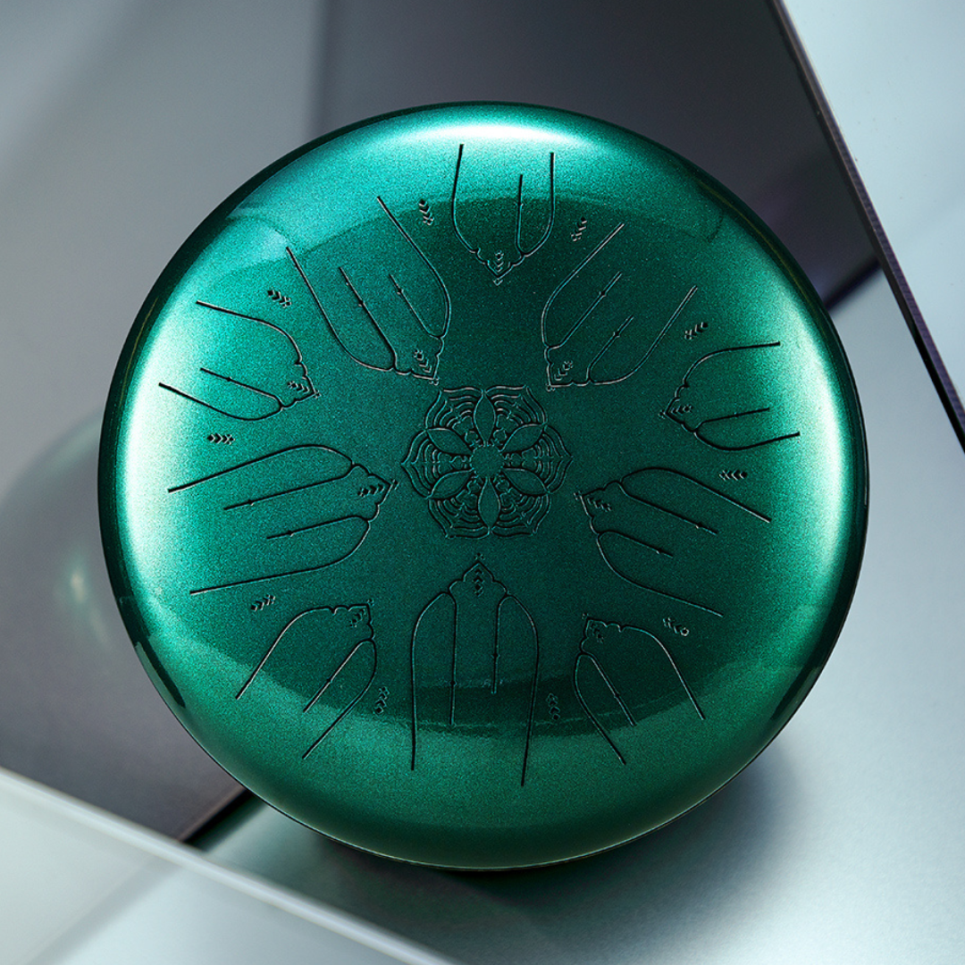 Close-up photo of Hluru EQ Ethereal Drum in emerald green, highlighting 10-note design and flower engraving at the center.