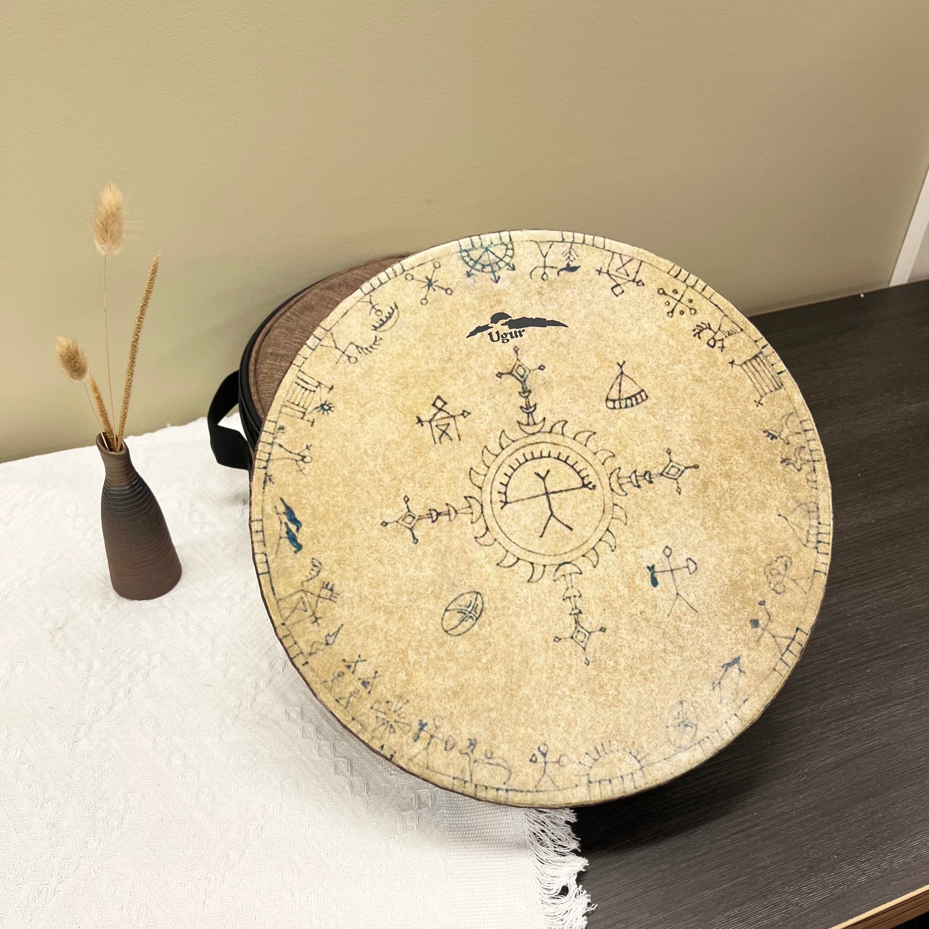 Handcrafted shamanic ocean drum with tribal symbols on natural beige skin and wooden frame.